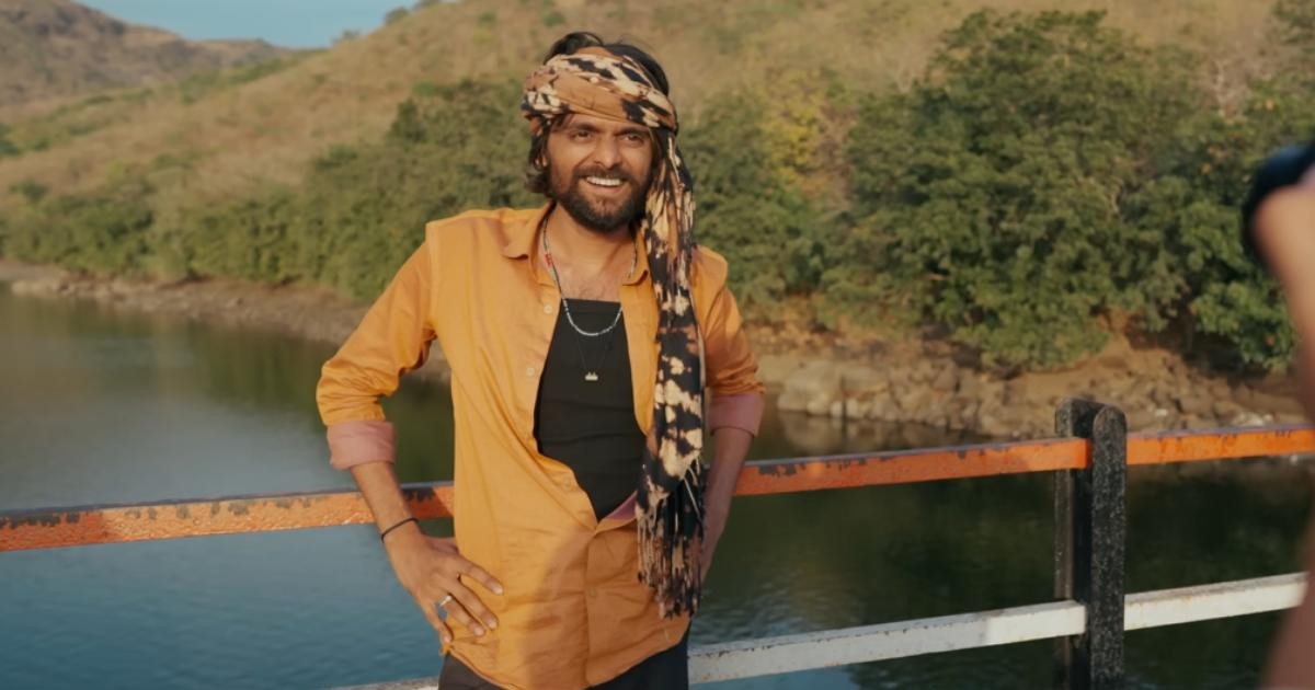 Karan Joshi standing on bridge in character from Laalo